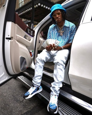 Rich The Kid Wearing A Fendi Bucket Hat Blue Shirt Jeans And Blue Ff Sneakers