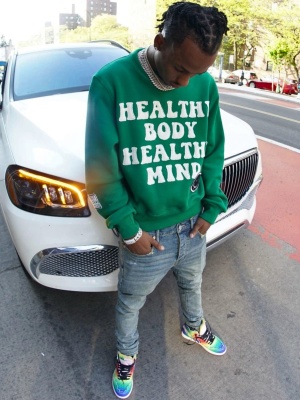 Rich The Kid Wearing An Amiri Green Sweatshirt With Amiri Stack Jeans And Nike X J Balvin Sneakers