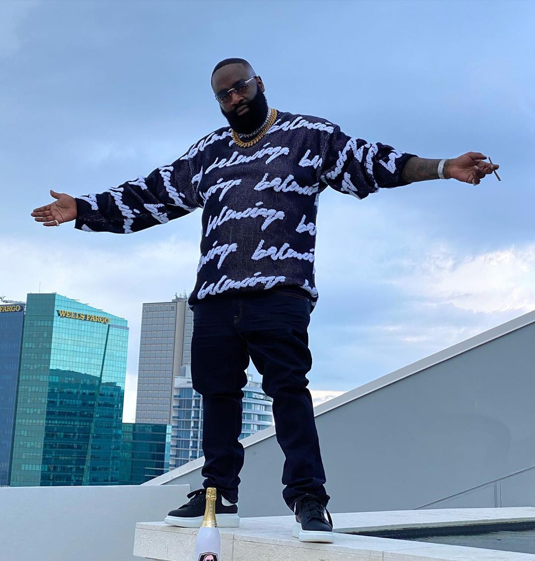 Rick Ross Spreads His Arms In a Balenciaga Sweater & McQueen Sneakers