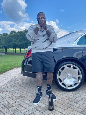 Rick Ross Wearing A Balenciaga Sweater With Balenciaga Socks And Nike Air Force 1 Low Suede Sneakers