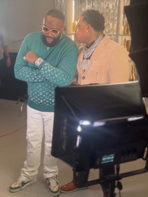 Rick Ross Wearing A Louis Vuitton Green Sweater White Carpenter Jeans And Lv Trainer Sneakers