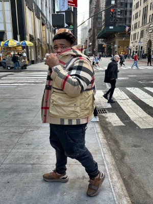 Rod Wave Wearing A Burberry Wool Check Hat With A Layered Coat Vest Jeans And Brown Strap Sneakers
