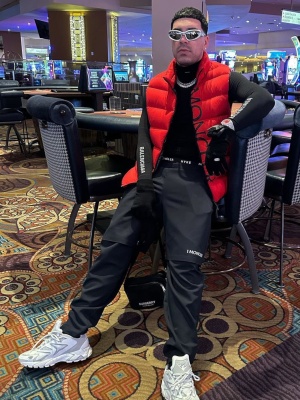 Ryan Castro Wearing Balenciaga Silver Sunglasses With A Moncler Vest And Pants And Louis Vuitton Sneakers