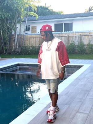 Rylo Rodriguez Wearing A Chrome Hearts Red Cross Hat With A Kapital Bandana Sleeve And Balenciaga Red Runner Sneakers