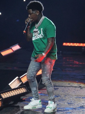 Rylo Rodriguez Wearing A Green Louis Vuitton T Shirt With Amiri Bandana Jeans And Louis Vuitton Green Trainer Sneakers