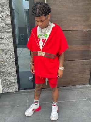 Rylo Rodriguez Wearing A Gucci Red Cut Off Hoodie Blade Logo Tee Web Socks And Rhyton Sneakers