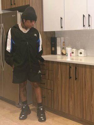 Rylo Rodriguez Wearing An All Black Balenciaga Track Jacket Shorts And Sneakers Outfit