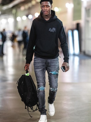 Sauce Gardner Wearing An Amiri Black Logo Hoodie With Black Mx1 Jeans And White Star Patch Sneakers