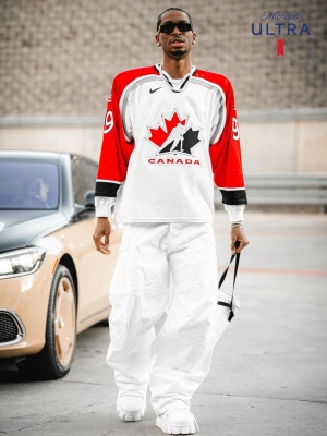 Shai Wearing A Wayne Gretzky Jersey Entire Studios White Pants Prada Boots And A White Chanel Bag