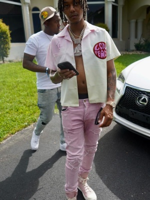 Skilla Baby Wearing A Valas Tie Dye Shirt With Amiri Pink Jeans And Rick Owens Pink Sneakers