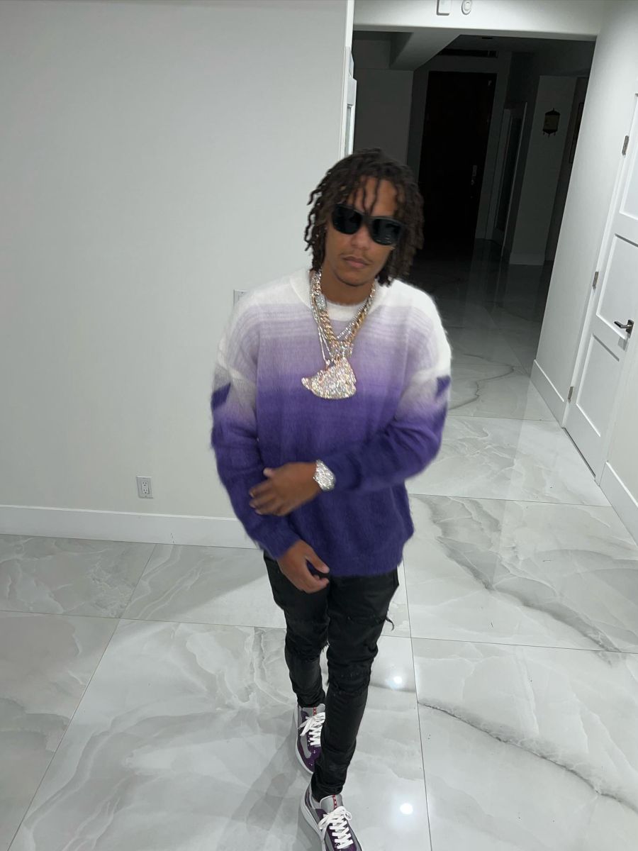 Skilla Baby Wearing a Purple Gradient Sweater With Matching Prada Sneakers