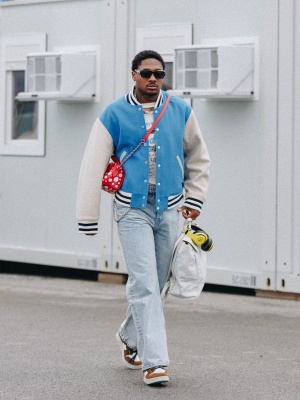 Stefon Diggs Wearing A Acne Varsity Jacket With A Lvxyk Bag Goyard Backpack Blue Jeans And Loewe Sneakers