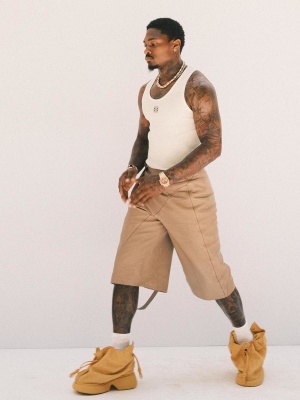 Stefon Diggs Wearing A Loewe White Tank Top With Envelope Shorts And Bag Boots