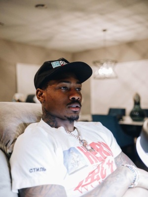 Stefon Diggs Wearing A Rhude Black Paneled Hat And A Heron Preston White T Shirt