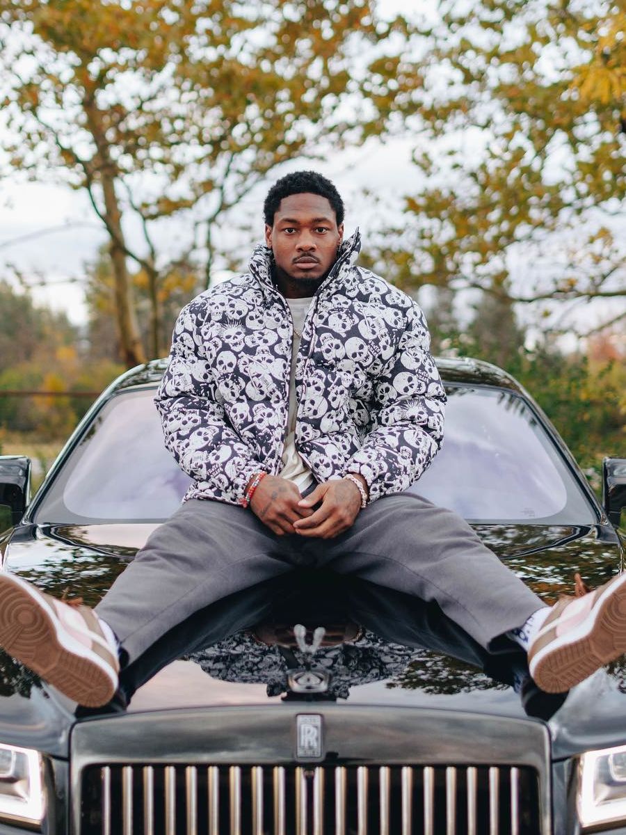 Stefon Diggs Relaxes Atop His Rolls Royce In a Skull Puffer & Stussy Dunks