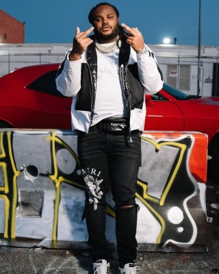 Tee Grizzley Wearing A Moncler Methot Jacket With Amiri Black Cherub Jeans A Saint Laurent Belt Bag And Amiri White Low Top Skeleton Sneakers