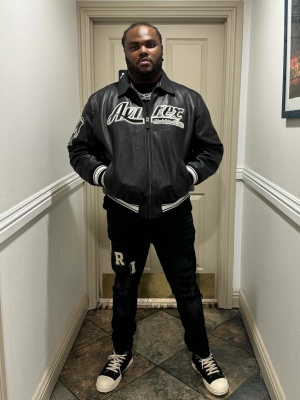Tee Grizzley Wearing An Avirex Leather Jacket With Amiri Logo Jeans And Rick Owens Sneakers