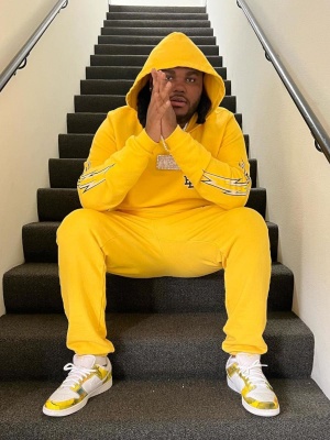Tee Grizzley Wearing An Eric Emanuel Yellow Lightning Hoodie And Sweatpants With Nike Dunk Low White And Yellow Sneakers
