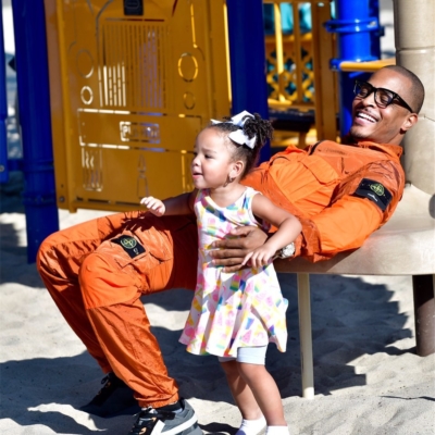 Ti Spending Time With His Daugher In An Stone Island Orange Jacket And Pants With Off White Sneakers