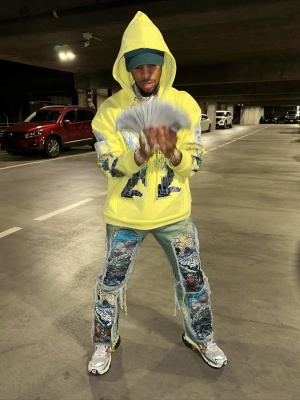 Toosii Wearing A Who Decides War Yellow Stained Glass Hoodie And Jeans With Balenciaga Sneakers
