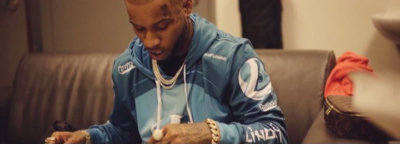 Tory Lanez Announcing Deal With Luninosity Gaming Wearing A Blue Luminosity Merch Hoodie