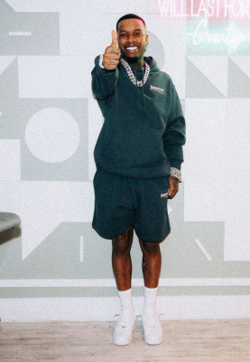 Tory Lanez Wearing A Balenciaga Political Campaign Hoodie And Sweatshorts With Nike Air Force 1 Sneakers