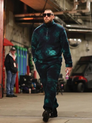 Travis Kelce Wearing Louis Vuitton Cyclone Sunglasses With Louis Vuitton Camo Fleece Jacket And Pants And Black Boots