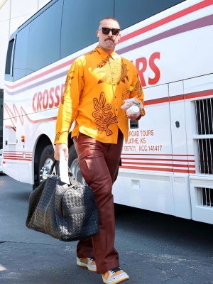 Travis Kelce Wearing Ysl Sunglasses Jacquemus Orange Shirt Amiri Pants And Nike Dunks