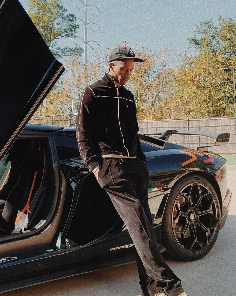Travis Scott Wearing a Celine Tracksuit & Cactus Jack Hat Next To His Lamborghini
