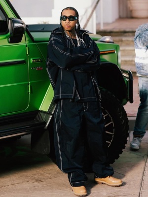 Tyga Wearing Bottega Sunglasses With A Navy Zip Anorak Jacket And Navy Baggy Pants With Timberland Boots