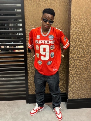 Vini Jr Wearing A Supreme Red Footblal Jersey With Indigo Jeans And Nike X Louis Vuitton Sneakers