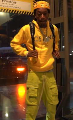 Wiz Khalifa Wearing A Celine Yellow Hoodie With Rick Owens Acid Cargo Pants And Celine Black Trekking Backpack