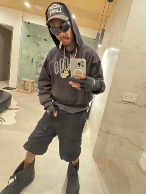 Wiz Khalifa Wearing A Vetements Hat Balenciaga Hoodie Shorts And Boots