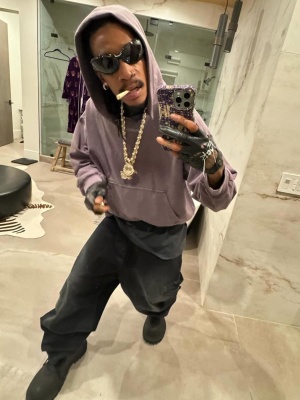 Wiz Khalifa Wearing Balenciaga Sunglasses Purple Faded Hoodie Black Cargo Pants And Black Boots