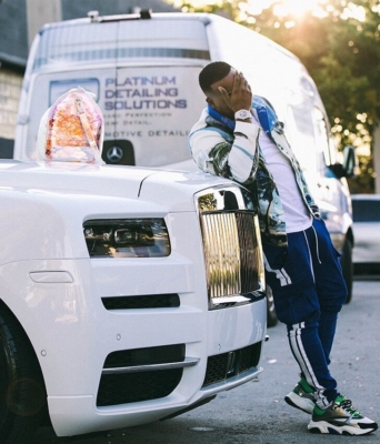 Yo Gotti Rests On His Rolls Roys In A Balmain Shirt Amiri Striped Blue Joggers With Dior Sneakers And A Lv Bag