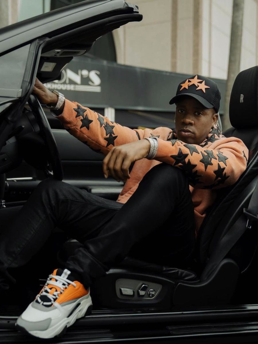 Yo Gotti Flexes In an Orange Star Trucker Hat & Hoodie With Dior 'B22' Sneakers