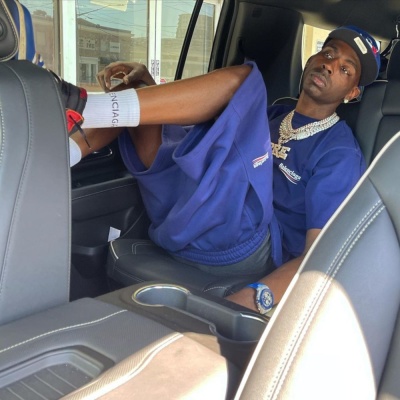 Young Dolph Wearing A Blue Balenciaga Political Tee And Shorts With An Audemars Blue Camo Watch