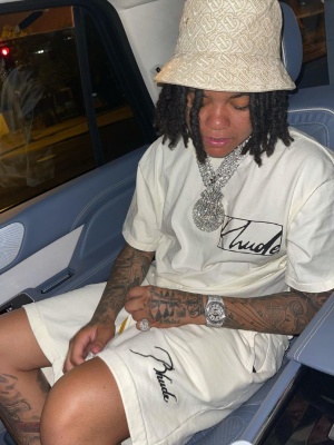 Young Ma Wearing A Burberry Bucket Hat With A Rhude T Shirt And Shorts