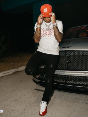 Yungeen Ace Wearing An Amiri Red Ma Hat With A Ma Paisley Shirt Black Mx1 Jeans And Jordan Sneakers