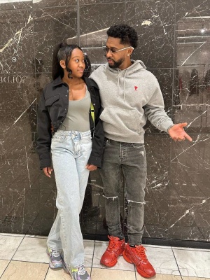 Zaytoven Wearing An Ami Paris Grey Logo Hoodie With Grey Ripped Knee Jeans And Balenciaga Sneakers